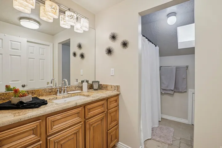 Double vanity with a granite countertop and integrated rectangular sink