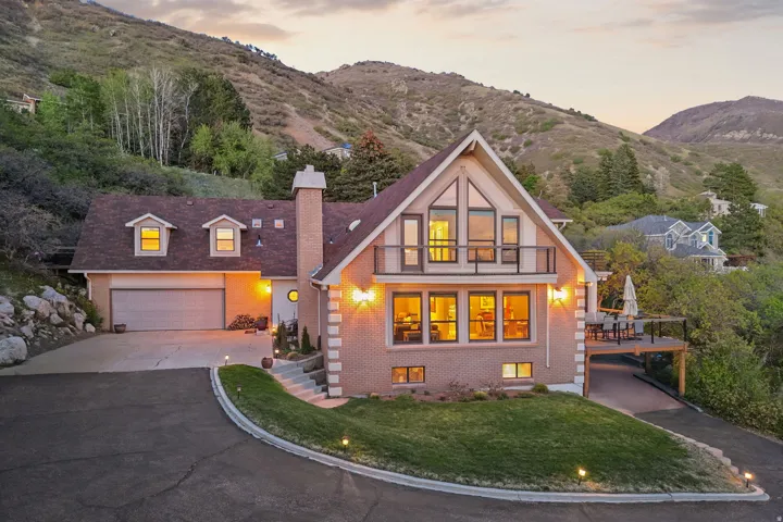 Brick exterior residence with a prominent A-frame architectural style and an attached two-car garage