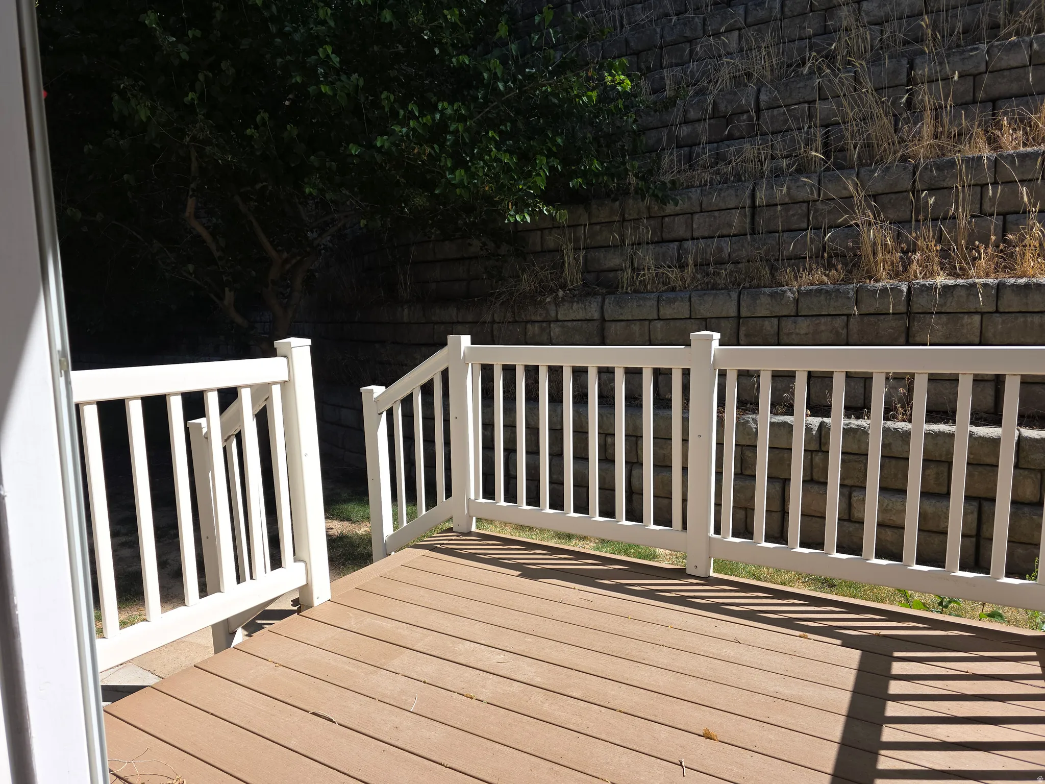 Exterior deck with wood-finish flooring and white perimeter railing