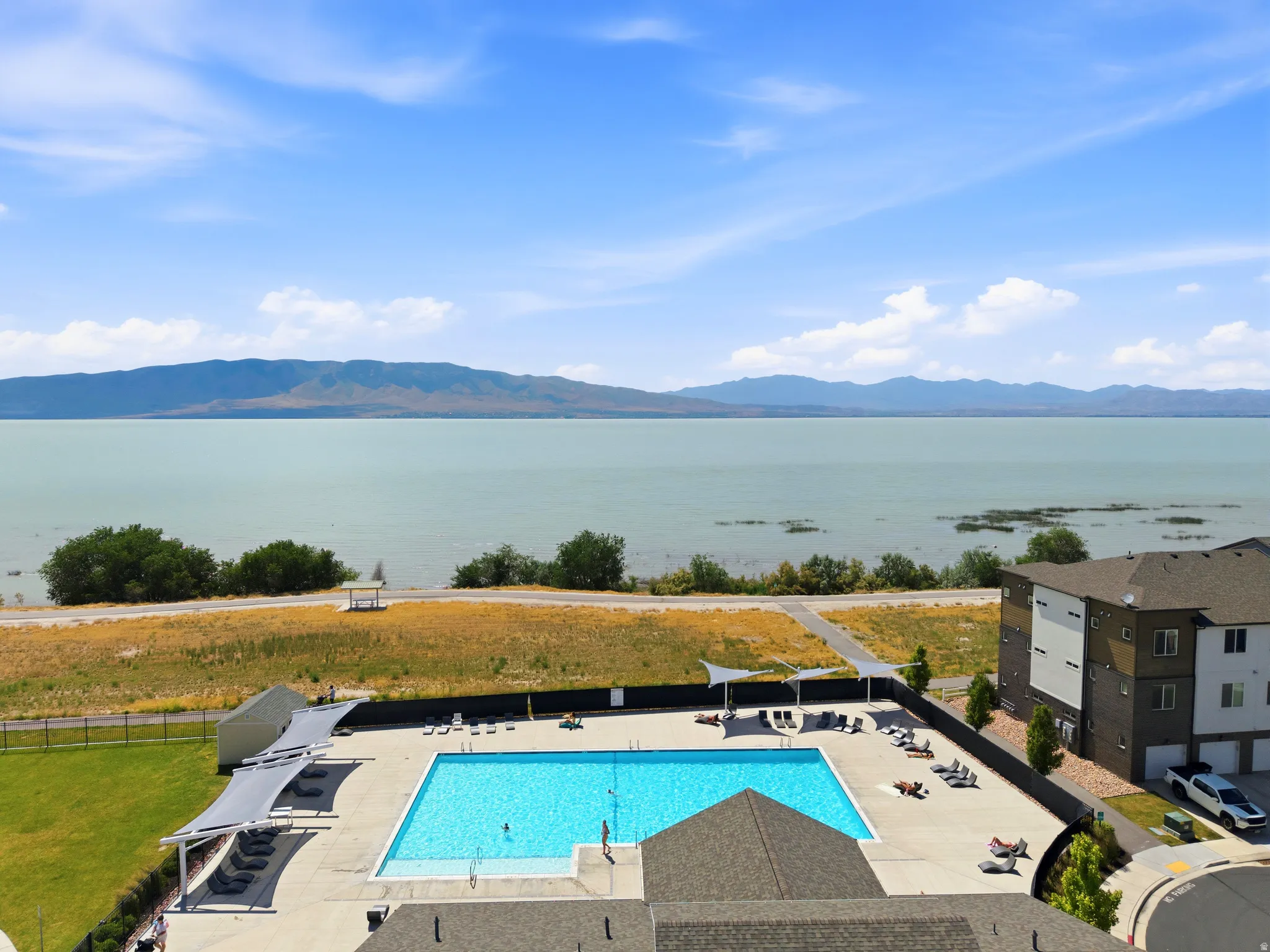 Expansive blue water body with distant mountains under a clear sky
