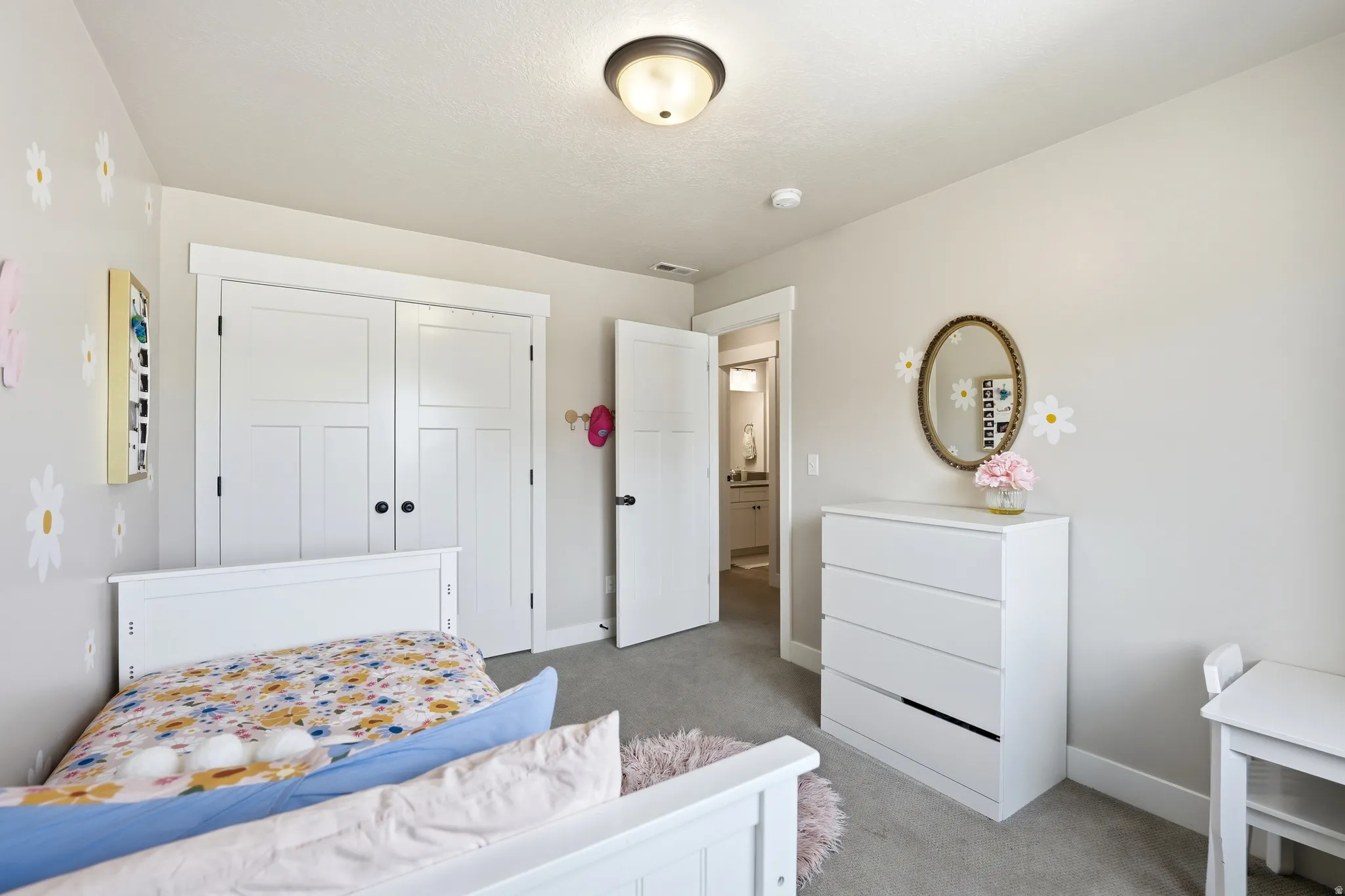 Neutral tone walls complement the light gray carpeted flooring