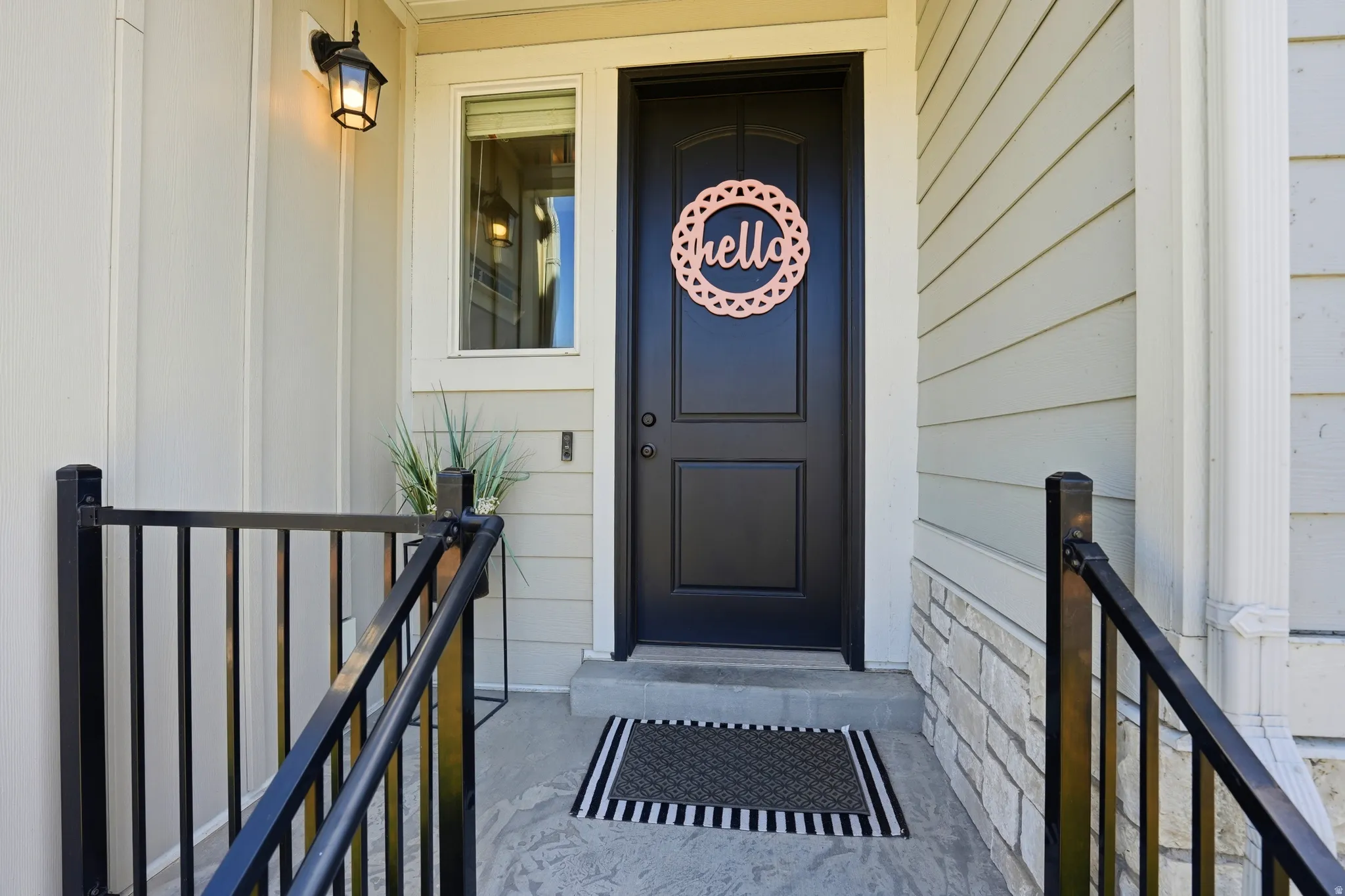 Entryway featuring a black paneled door, sidelight window, and an overhead lantern-style light fixture