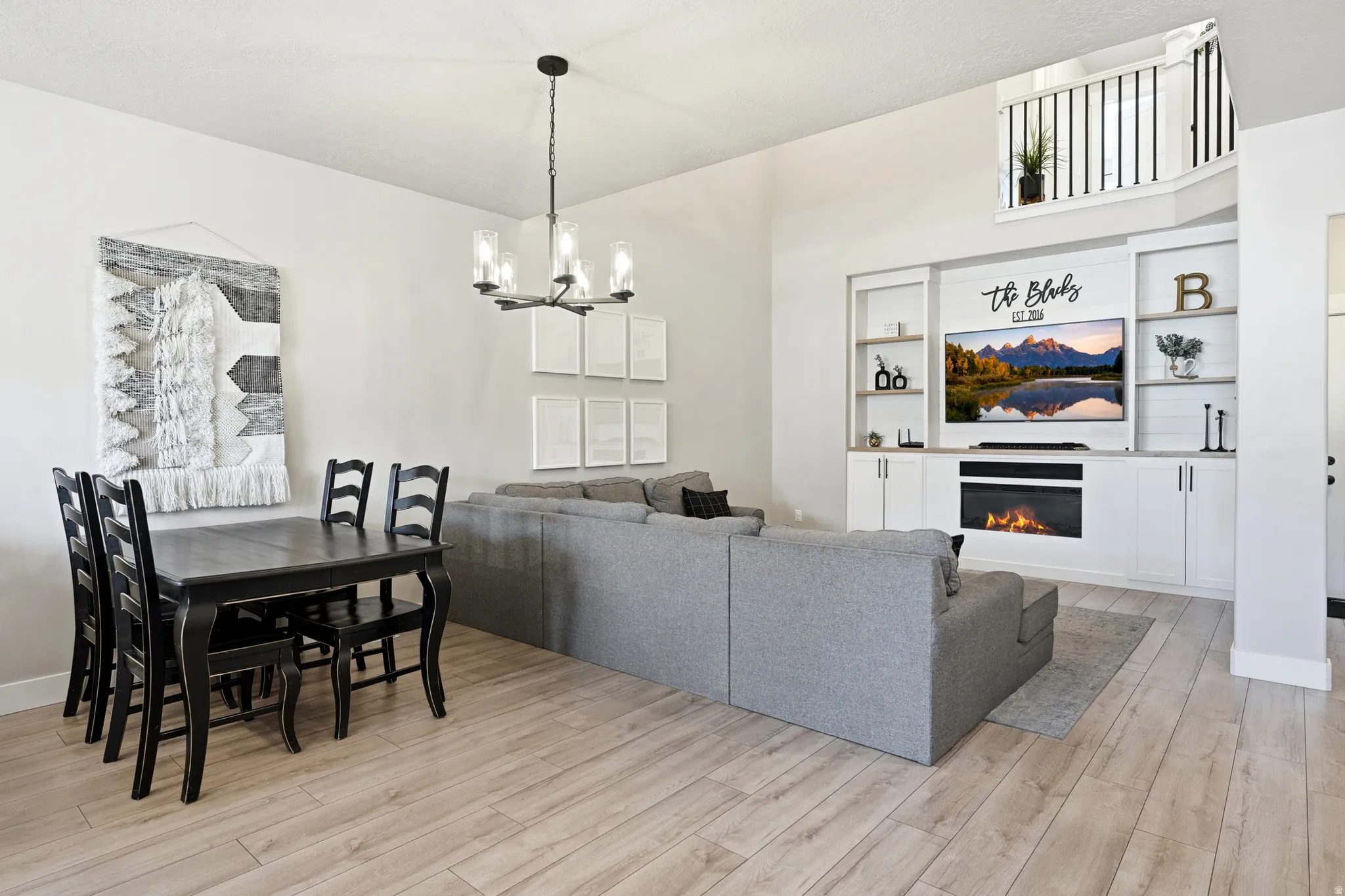 Open-concept living space with light wood-finish flooring
