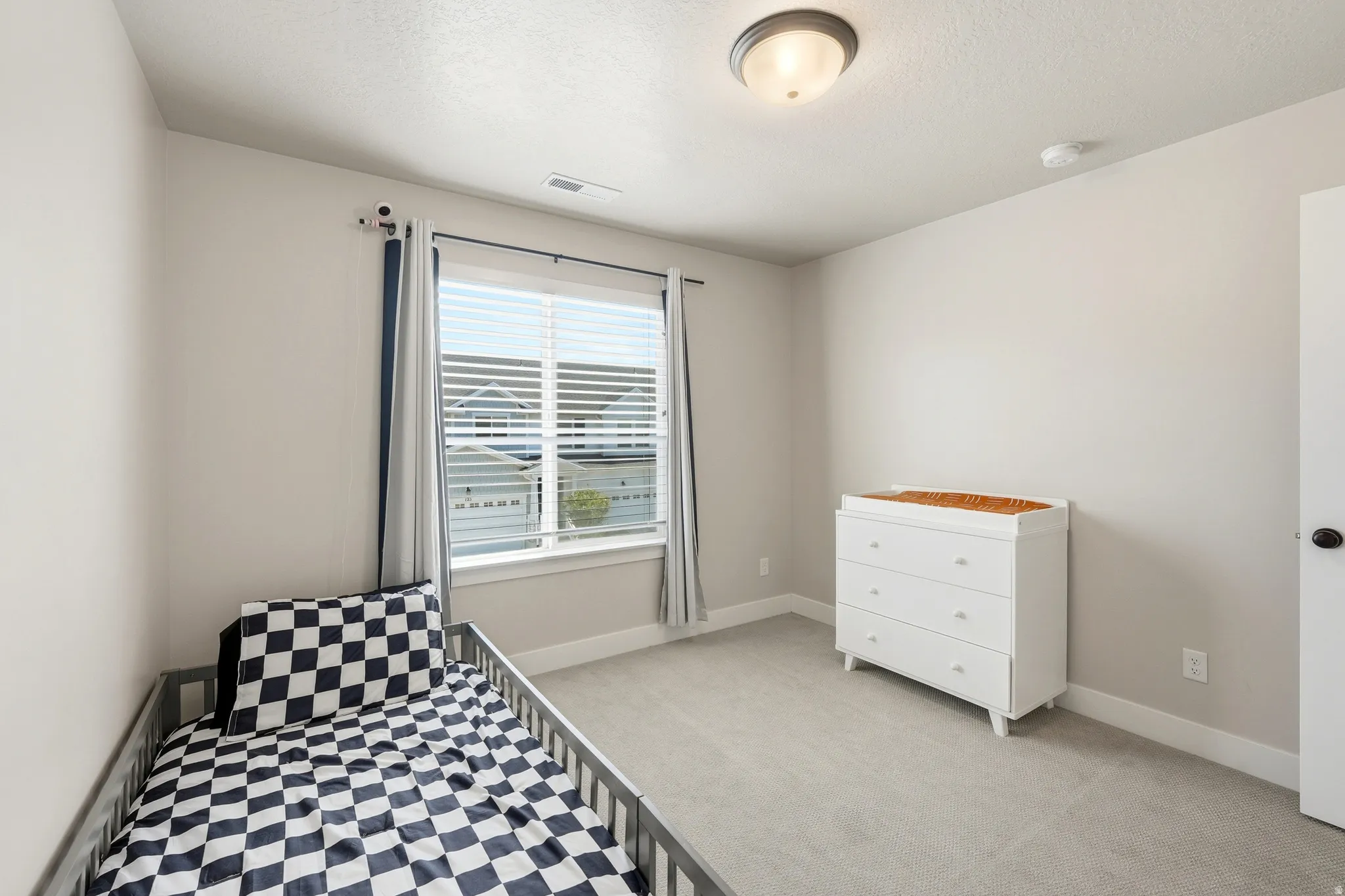 Neutral tone interior with light gray walls, light carpet flooring, and white trim