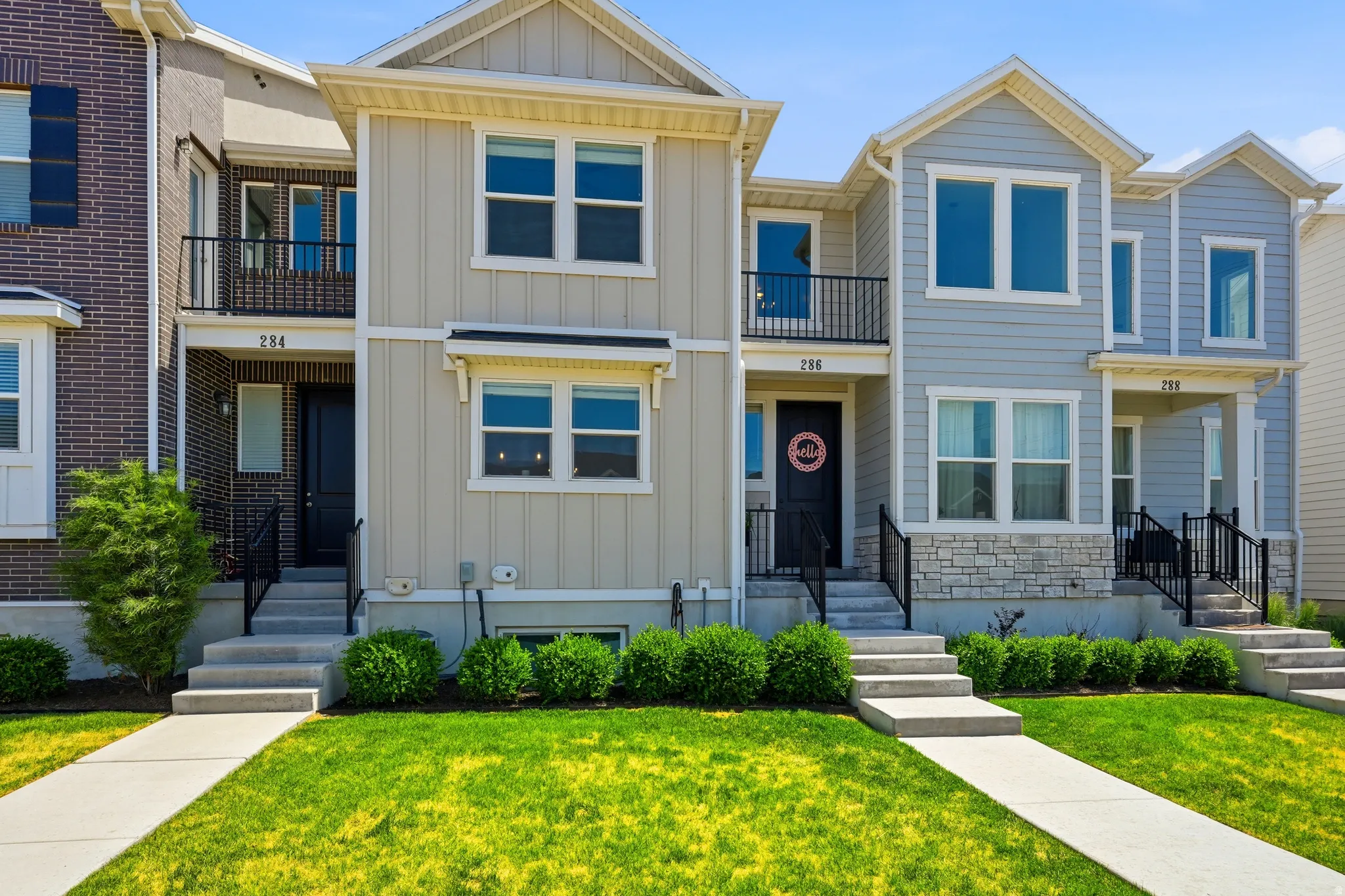Contemporary townhome exteriors featuring varied siding materials and stone accents