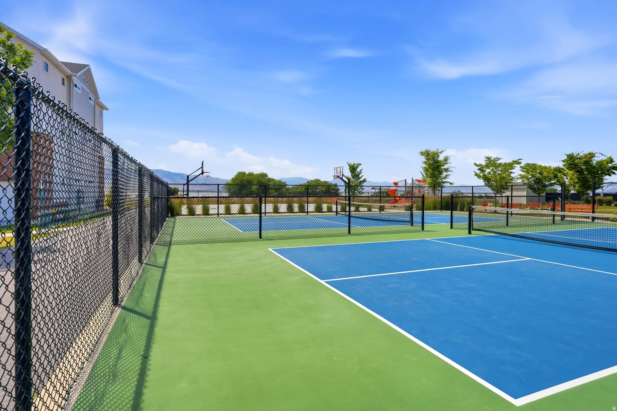 Outdoor sports courts featuring blue and green surfacing