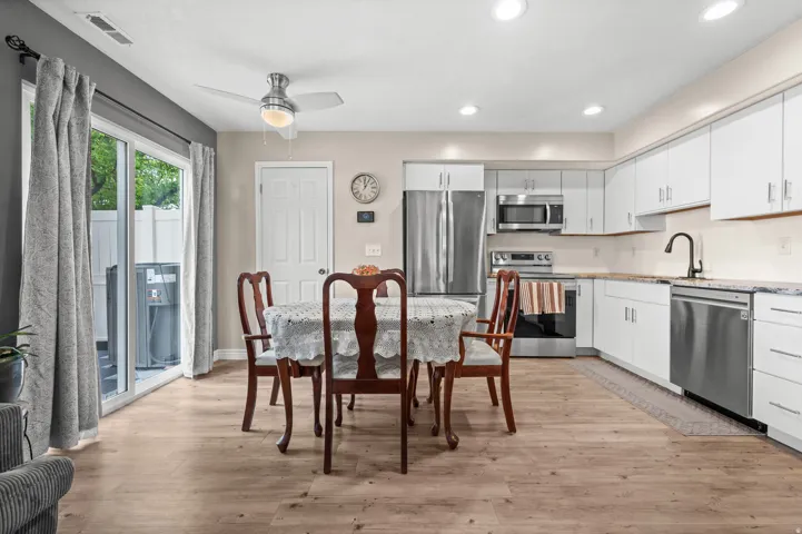 Open-concept kitchen and dining area featuring wood-finish flooring