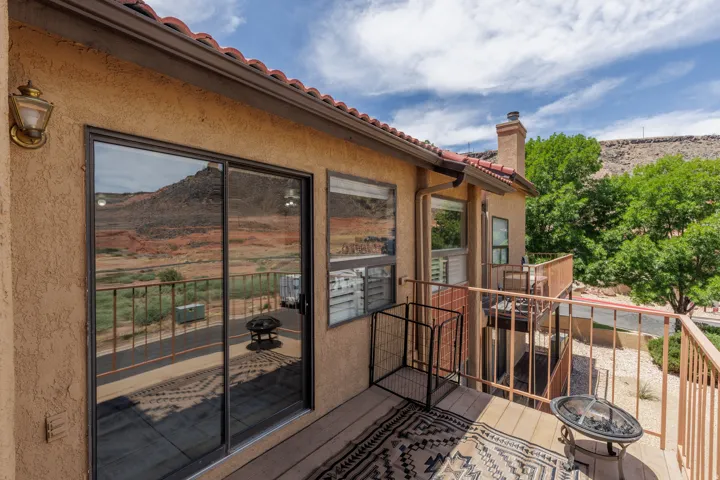 Terracotta roof tiles complement stucco exterior on outside deck