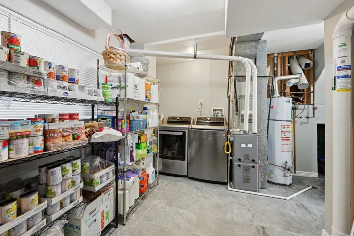 Dedicated laundry area with tile flooring and a window