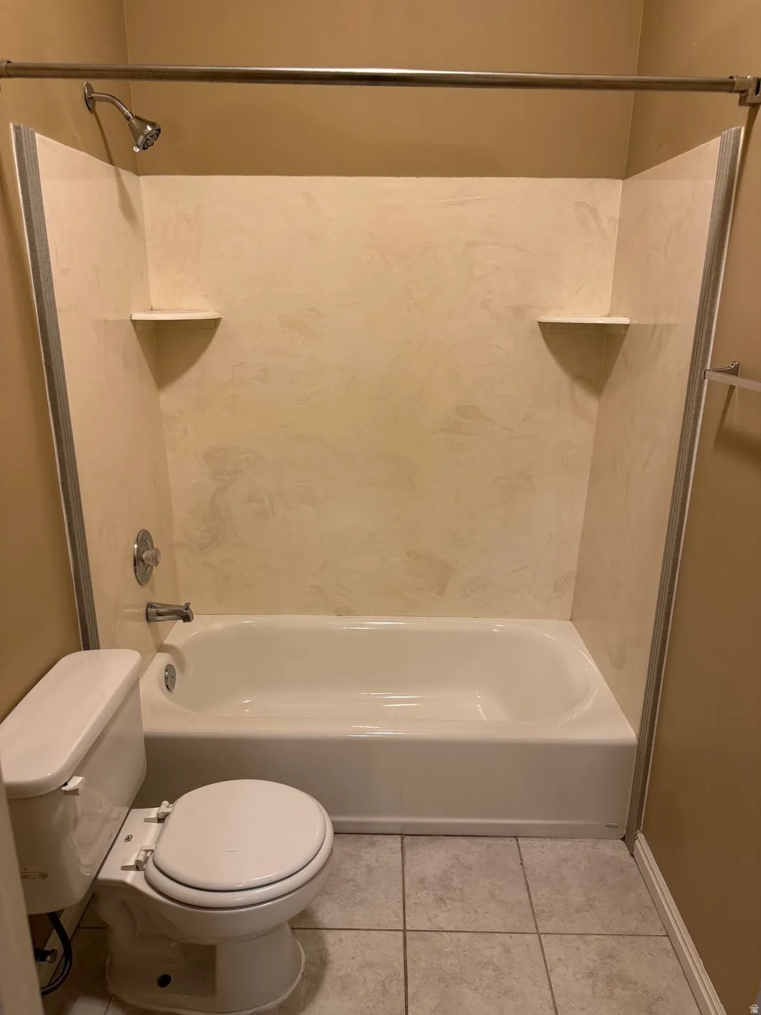 White bathtub and shower combination unit with integrated wall panels