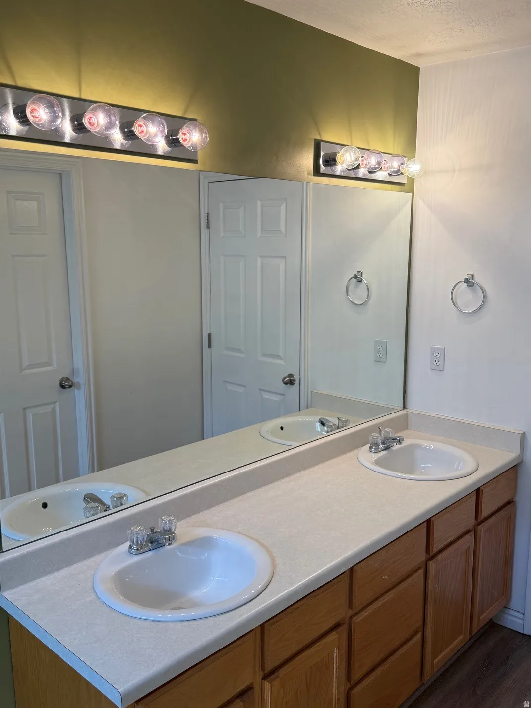 Master Bathroom w/ dual vanity with integrated sinks, laminate countertop, and wood-finish cabinetry