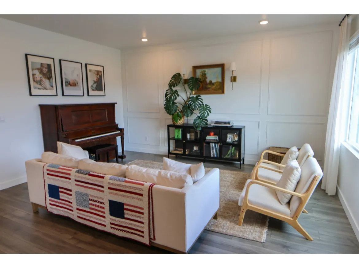 Bright living room featuring picture frame molding, wood-finish flooring and recessed lighting