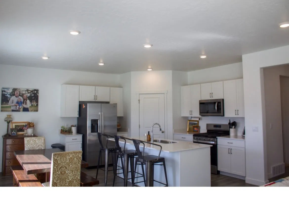 Kitchen and dining area with quartz countertops and corner pantry.