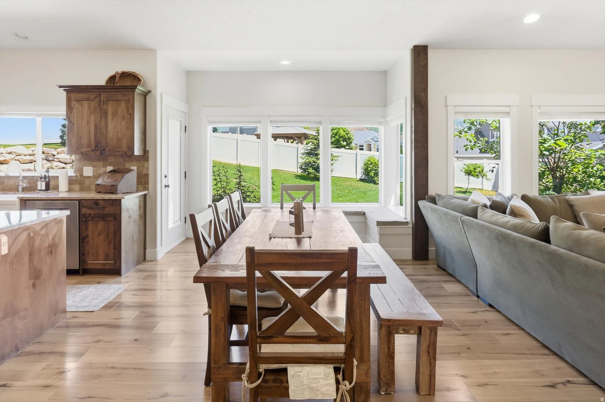 Expansive wood-finish flooring extending through the living area and dining space