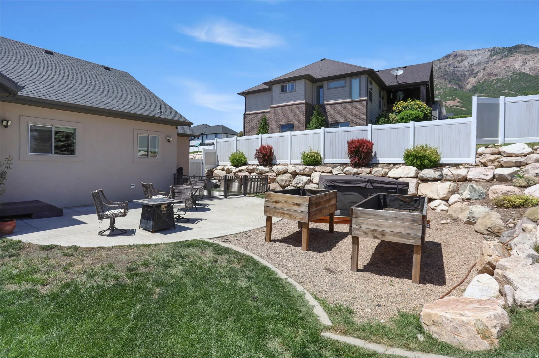 Outdoor patio space with stucco exterior and a gray shingle roof