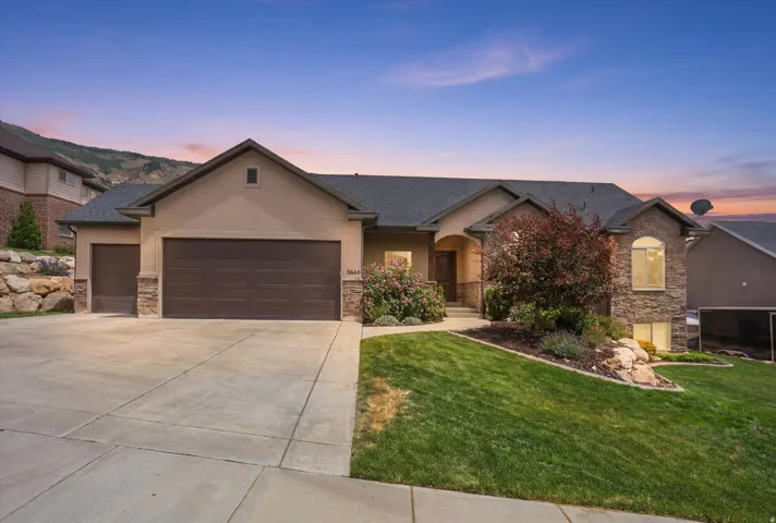 Ranch-style exterior with a stucco and stone facade