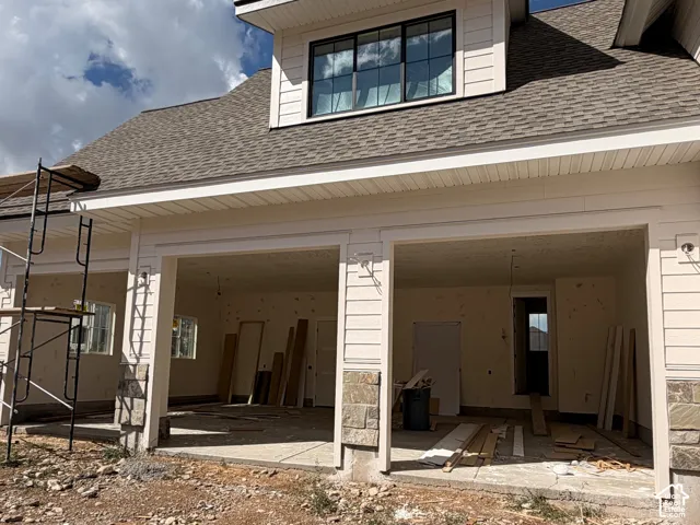 Two-bay garage entry with stone accents and exterior lighting fixtures