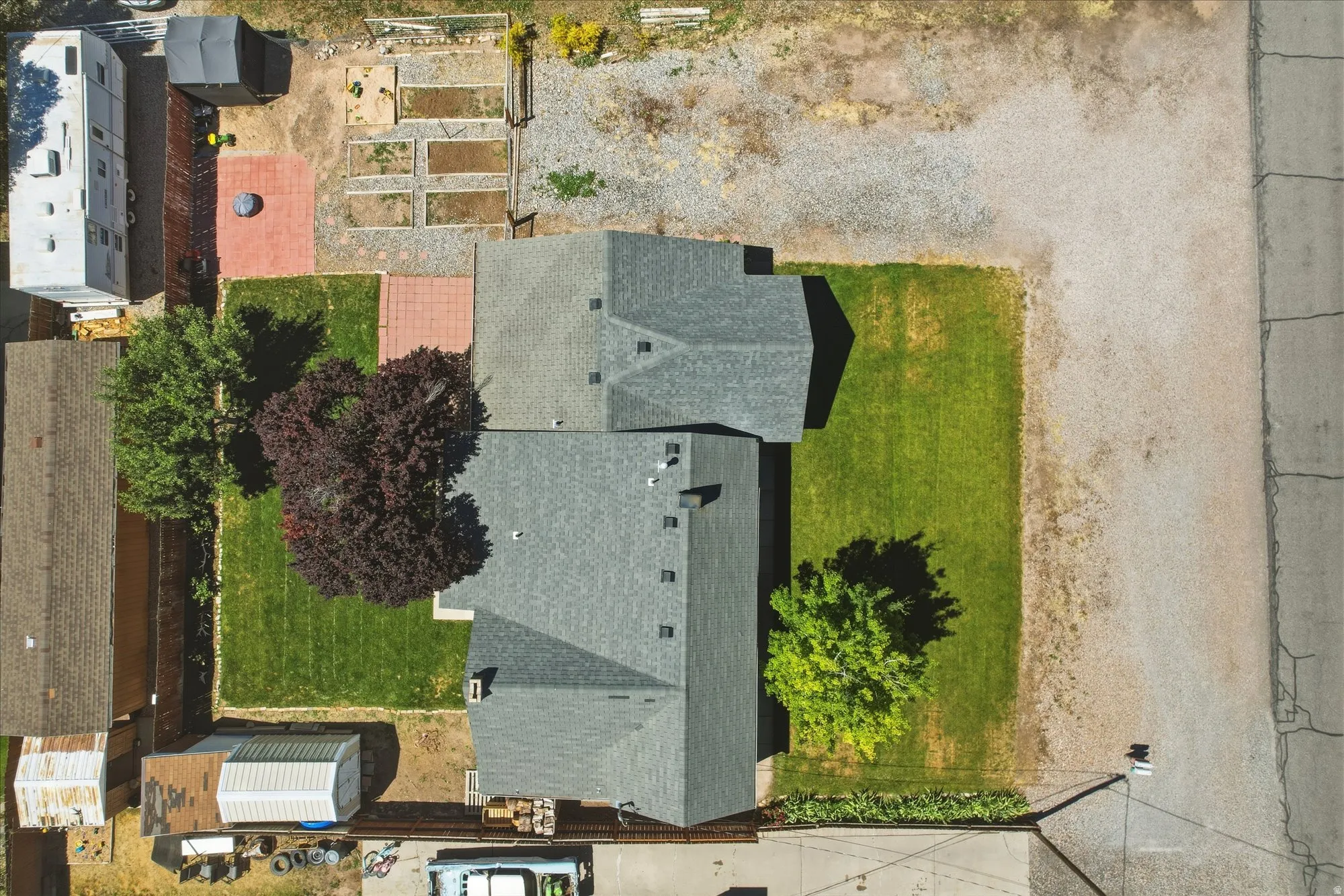 Aerial property overview featuring two structures with gray shingle roofing