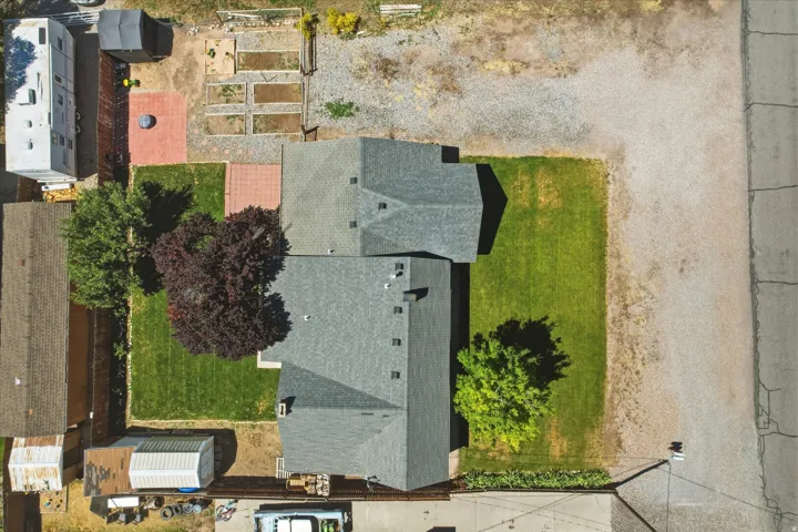 Aerial property overview featuring two structures with gray shingle roofing