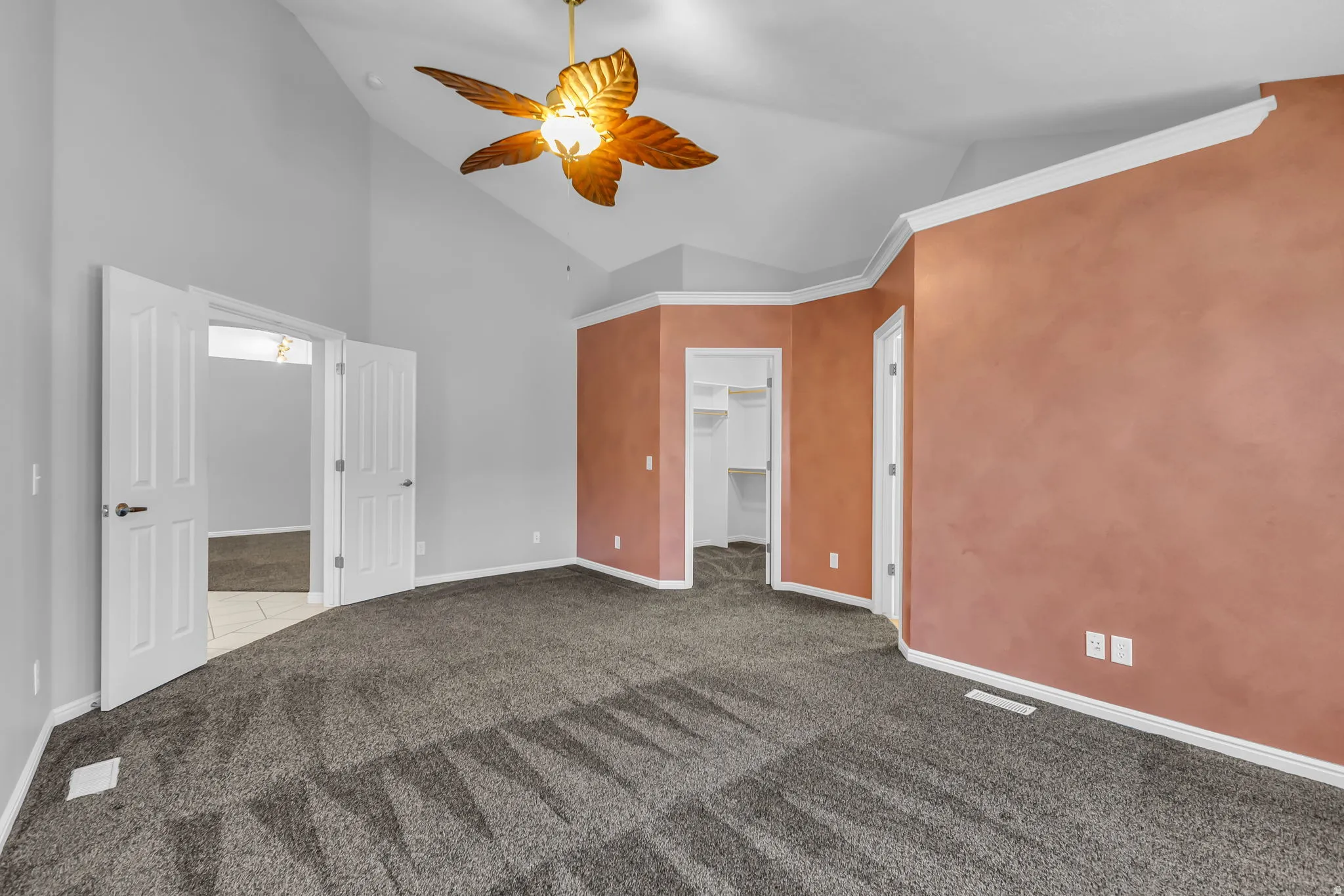 Spacious interior featuring vaulted ceilings and textured accent walls