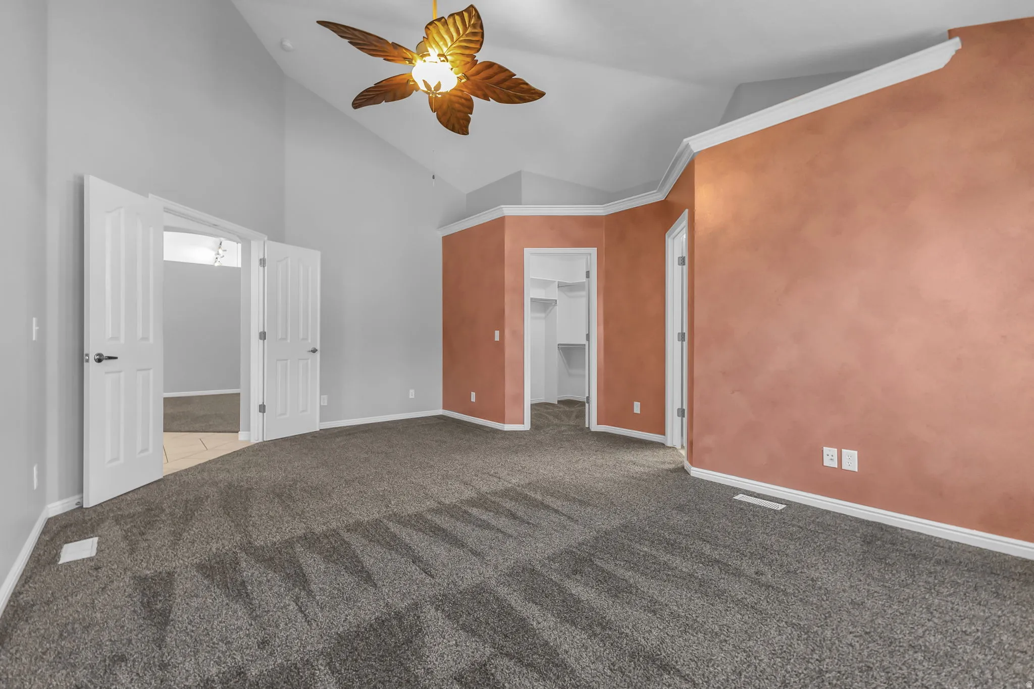 Spacious interior featuring vaulted ceilings and a decorative ceiling fan