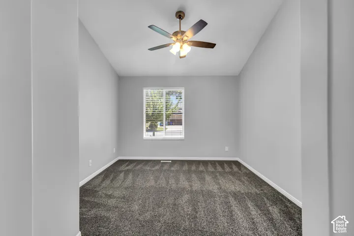 Room featuring textured carpeting, white baseboards, and neutral wall paint