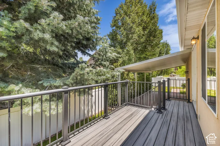 Expansive outdoor deck featuring wood-finish composite decking and dark metal railings