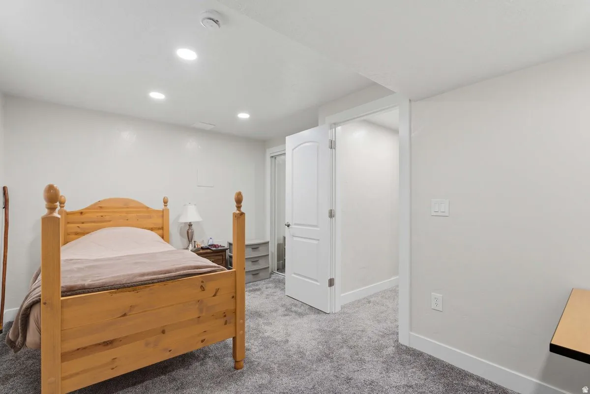 Spacious room featuring neutral carpeting and white walls