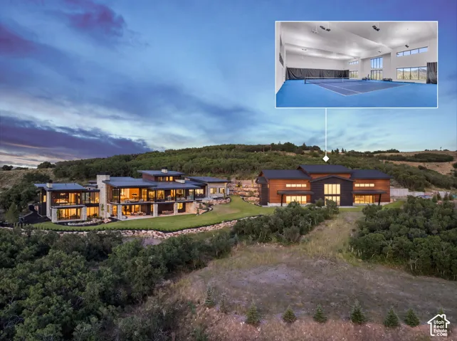 Multi-structure estate featuring contemporary architectural design, stone and wood-panel exterior finishes, expansive terraced landscaping, and a dedicated indoor athletic facility with a full-sized court