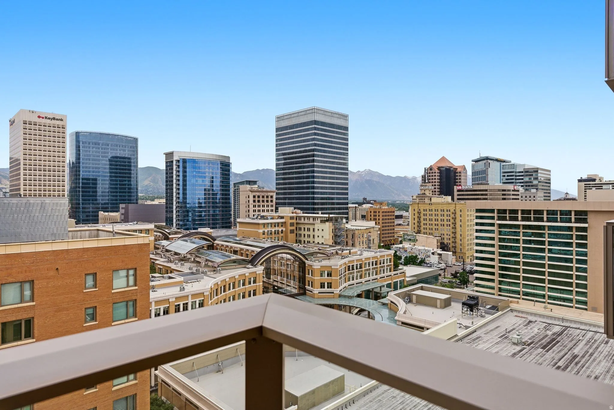 Expansive cityscape featuring diverse architectural styles and distant mountain ranges