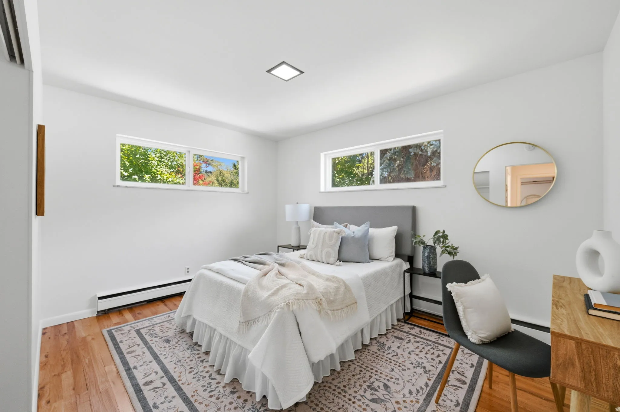 Bright room featuring wood-finish flooring and multiple horizontal windows