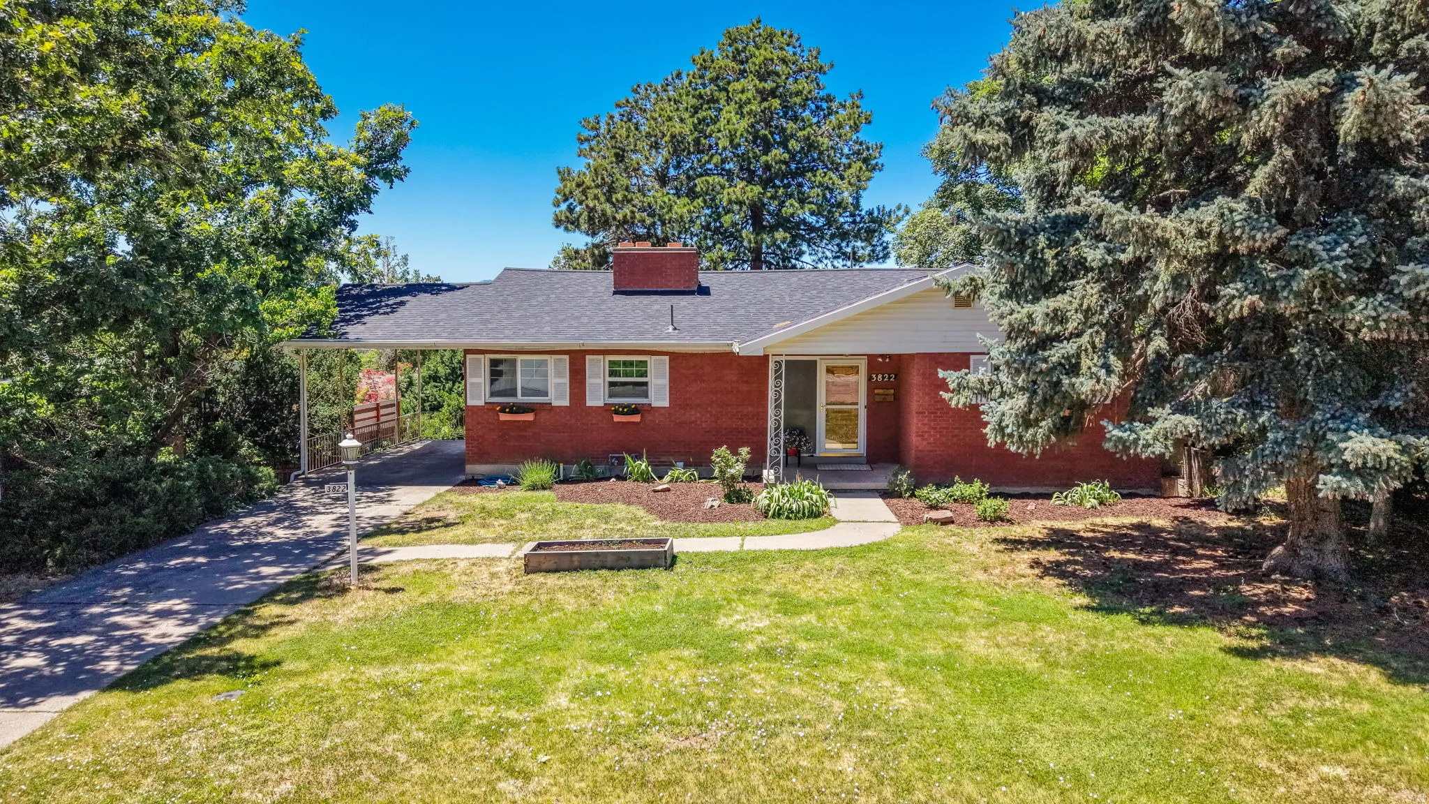 Brick exterior with white trim and a dark shingle roof