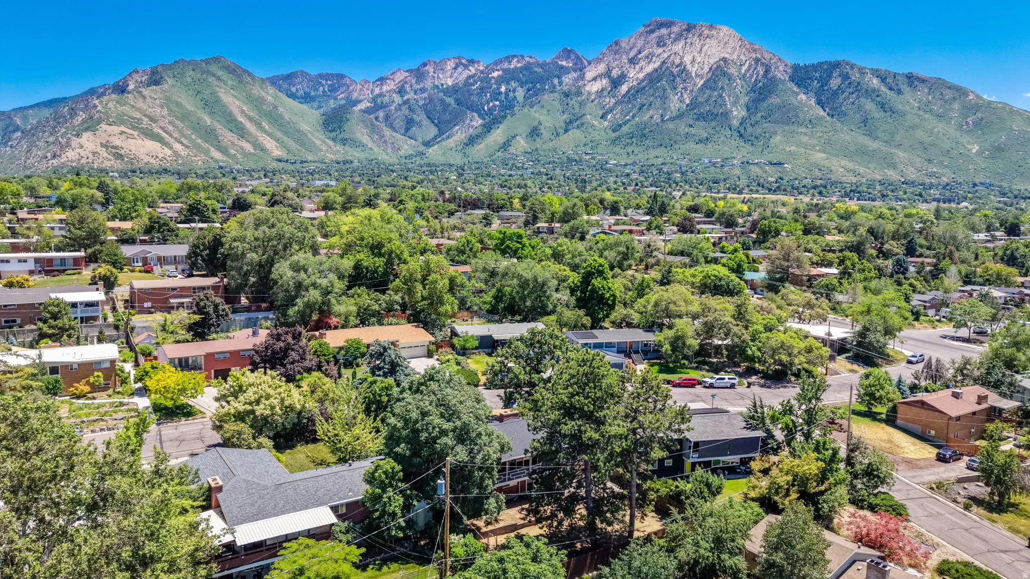 Expansive mountain backdrop with a lush green landscape