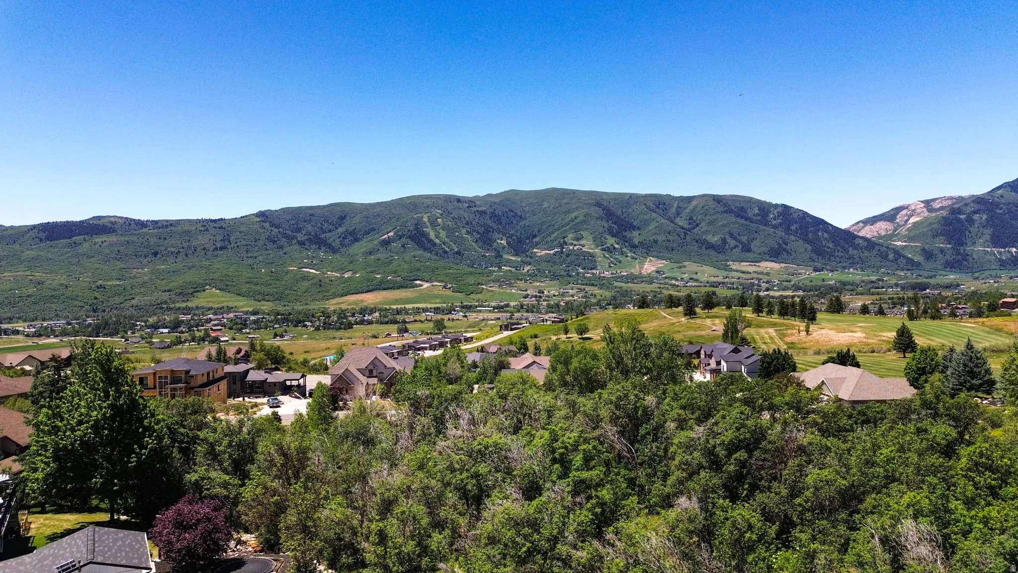 Expansive mountainous terrain with verdant hillsides