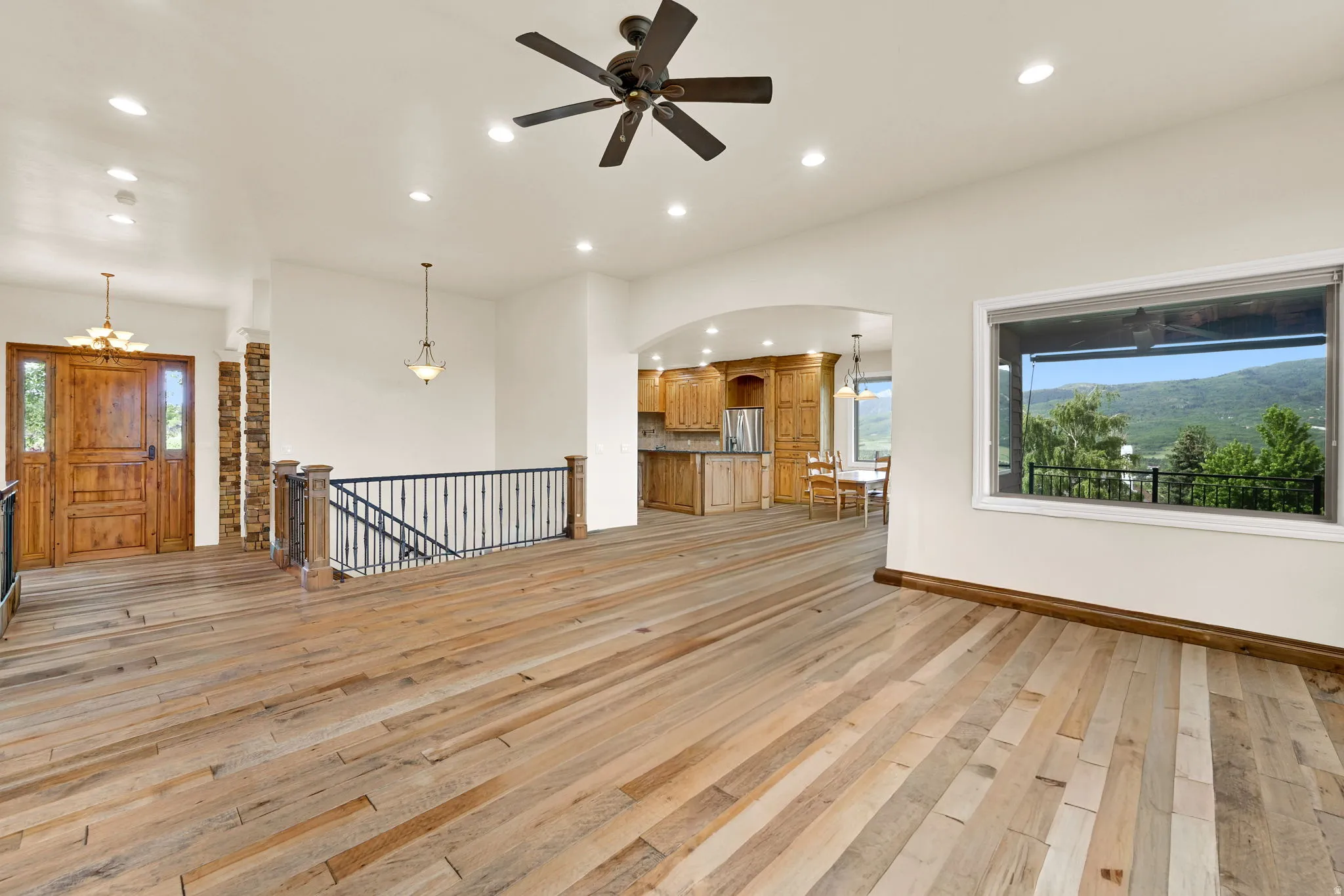 Expansive open-concept room with wood-finish flooring throughout