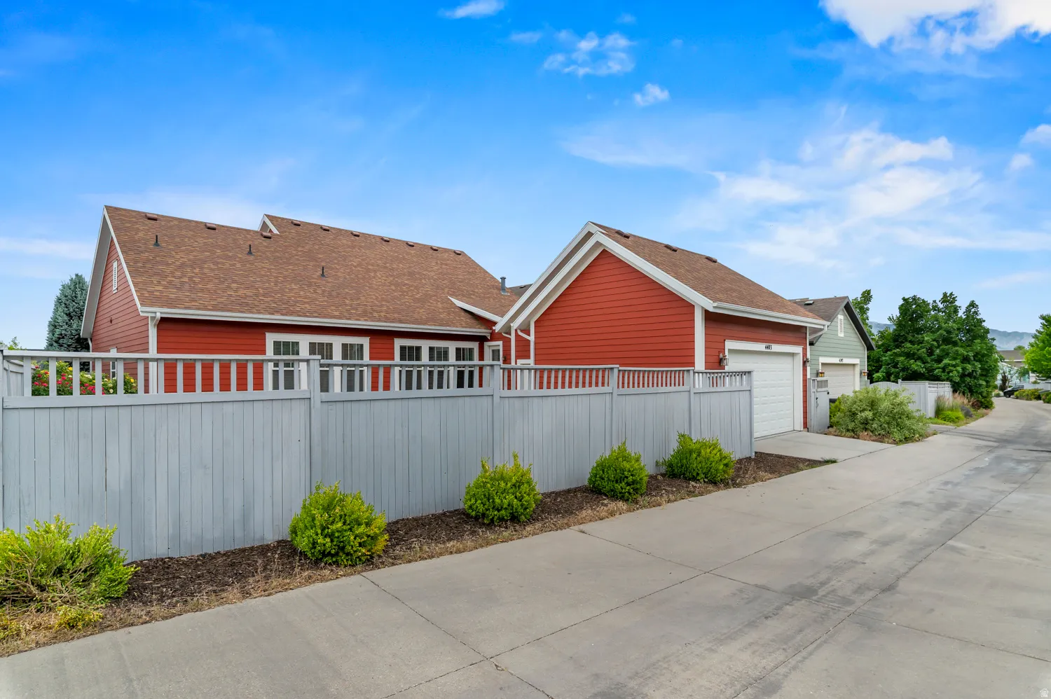 Red siding exterior with a brown shingle roof