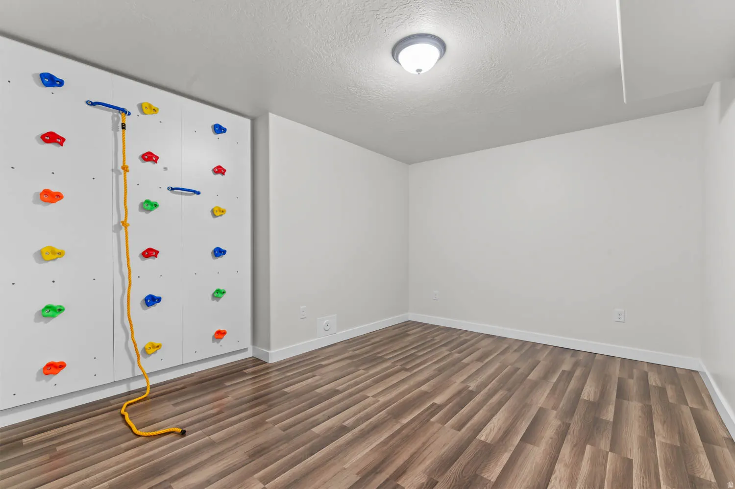 Accent wall featuring a built-in climbing wall with colorful holds