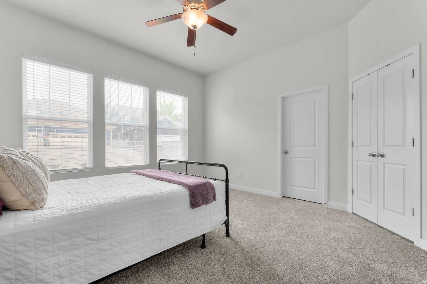 Room with neutral wall paint and grey carpet flooring
