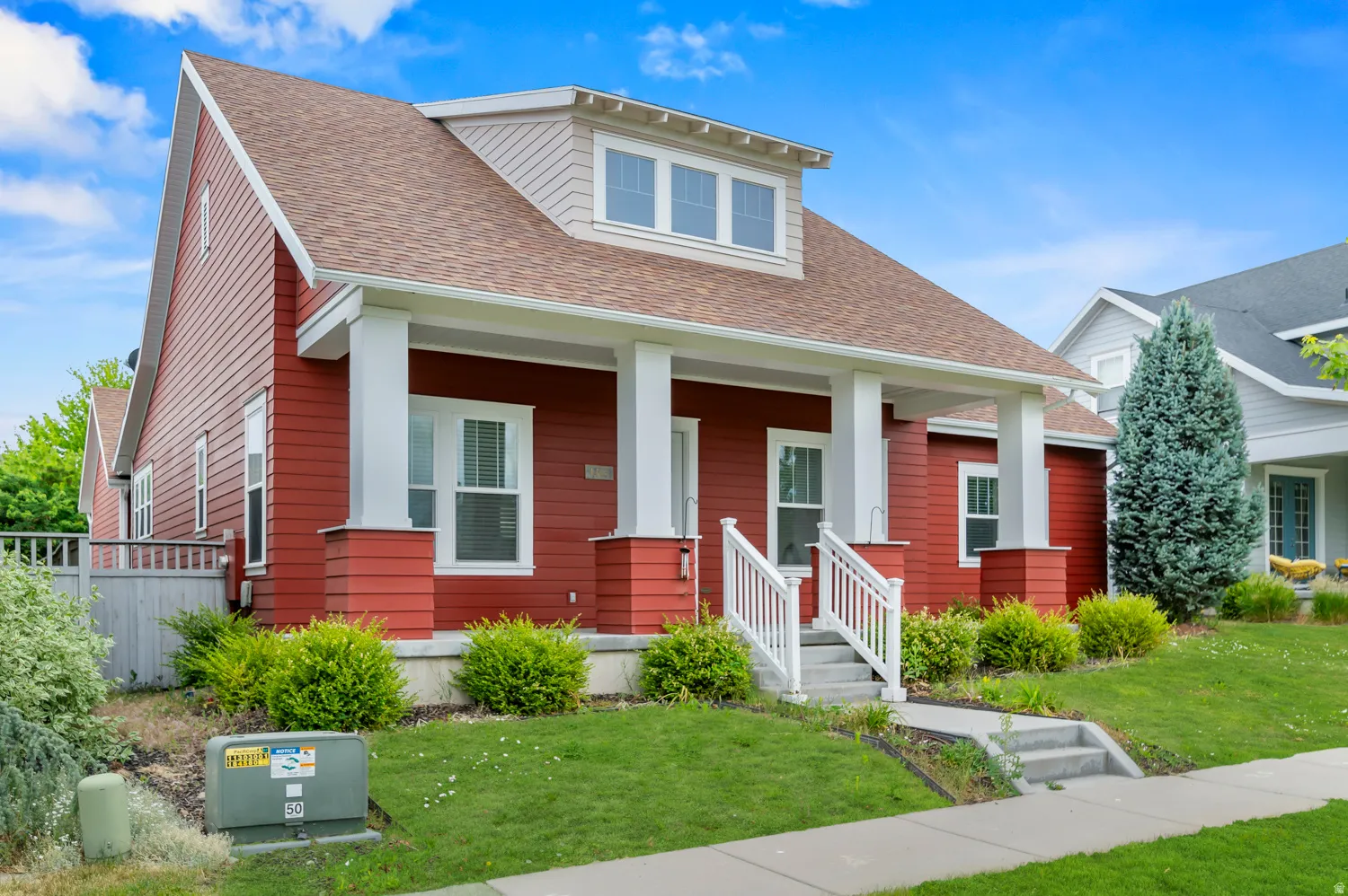Red siding exterior with a prominent front porch