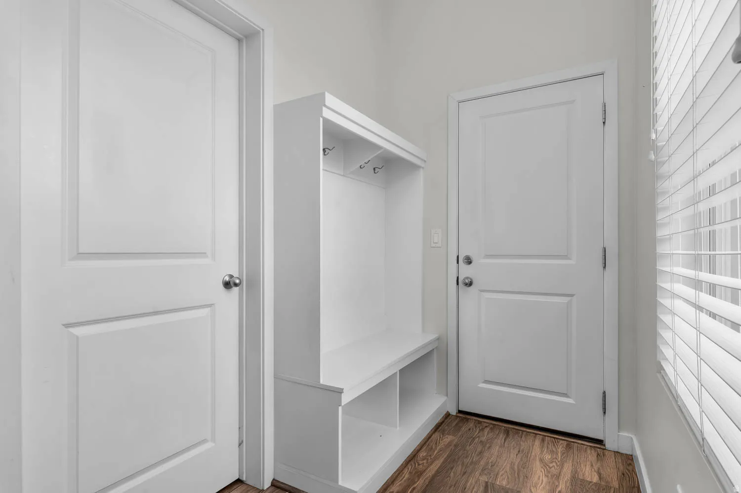 Entryway featuring a built-in mudroom bench with coat hooks and storage cubbies