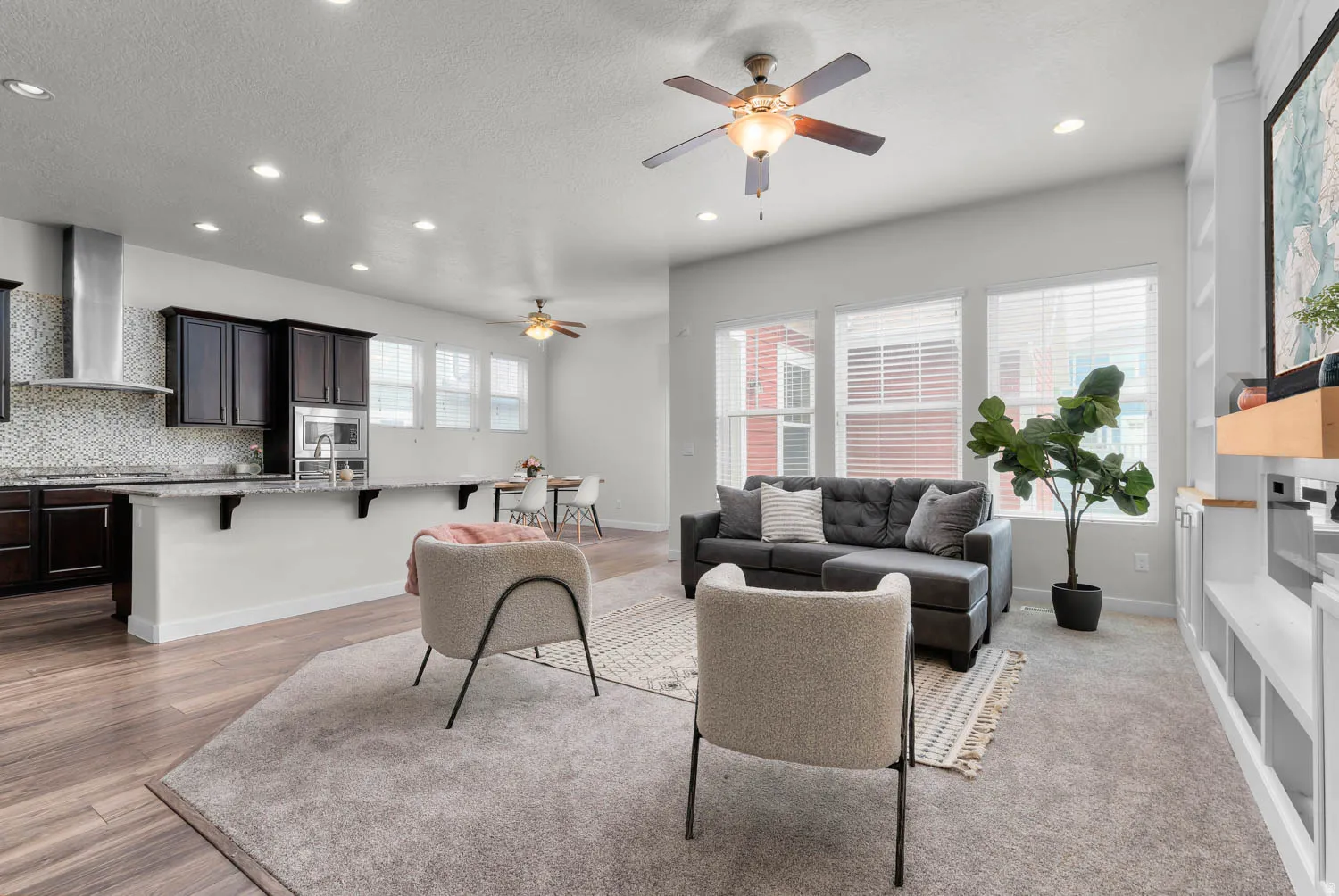 Expansive open-concept living area featuring wood-finish flooring and carpet