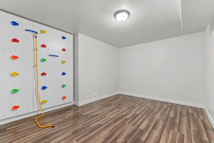 Accent wall featuring a built-in climbing wall with colorful holds
