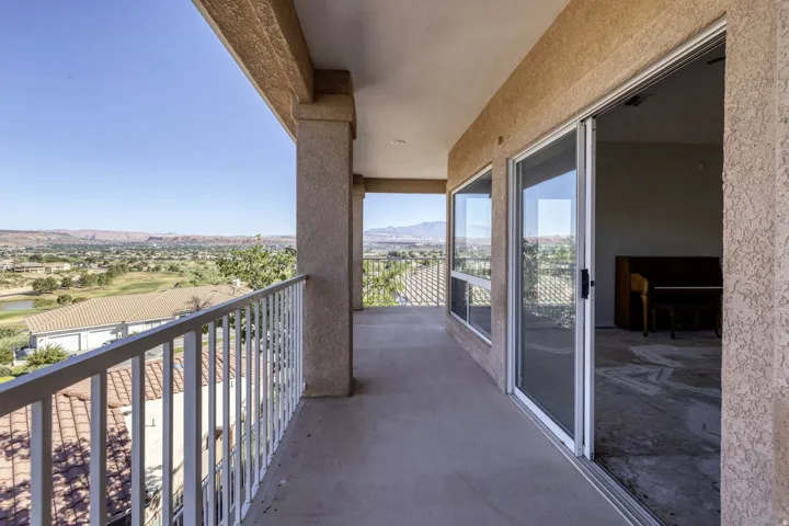 Private balcony with textured stucco exterior and concrete flooring