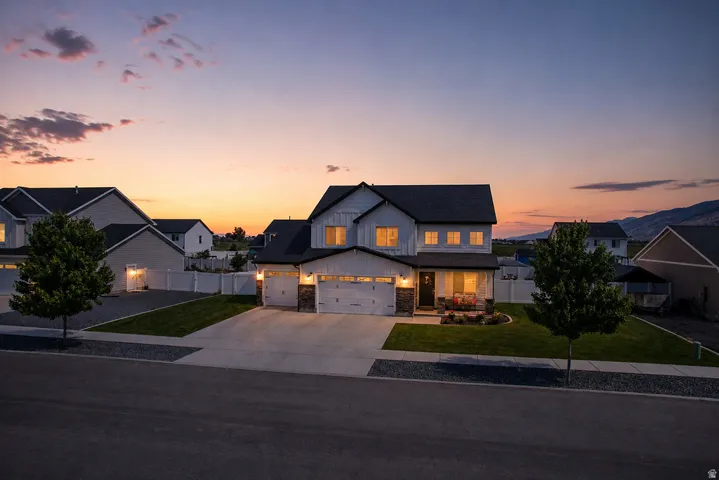 Modern farmhouse exterior with white vertical siding and dark trim