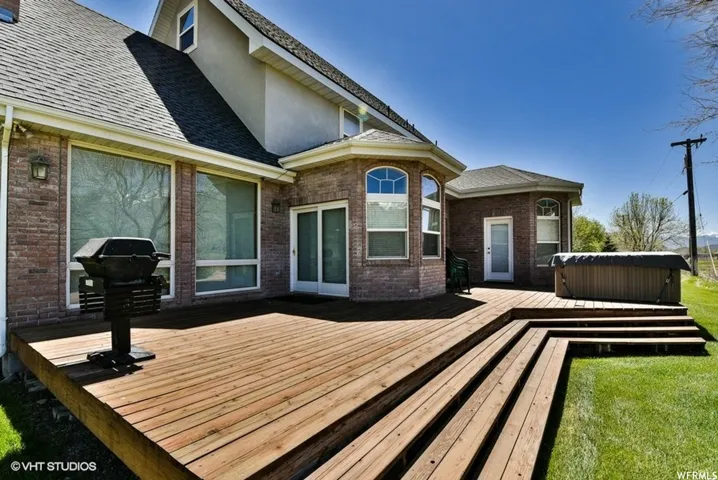 Expansive multi-level wood deck with integrated steps, ideal for outdoor entertainment