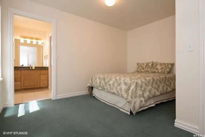 Bedroom featuring wall-to-wall carpeting and a neutral color palette