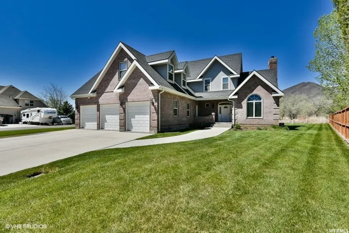 Brick and siding exterior featuring multiple gables and a multi-level roofline