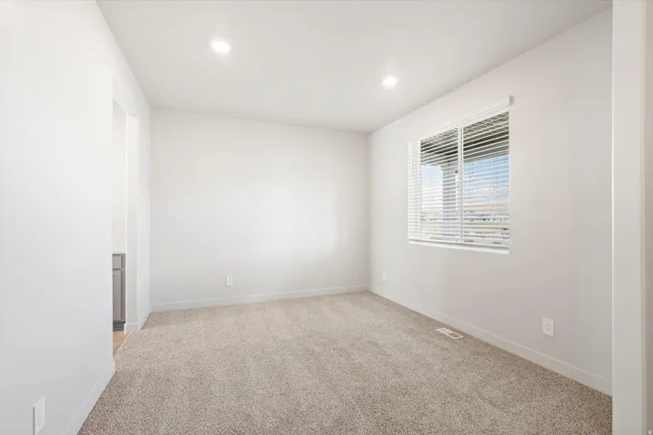**DISLCAIMER** Interior package may vary. Carpeted room with recessed lighting and a window featuring horizontal blinds