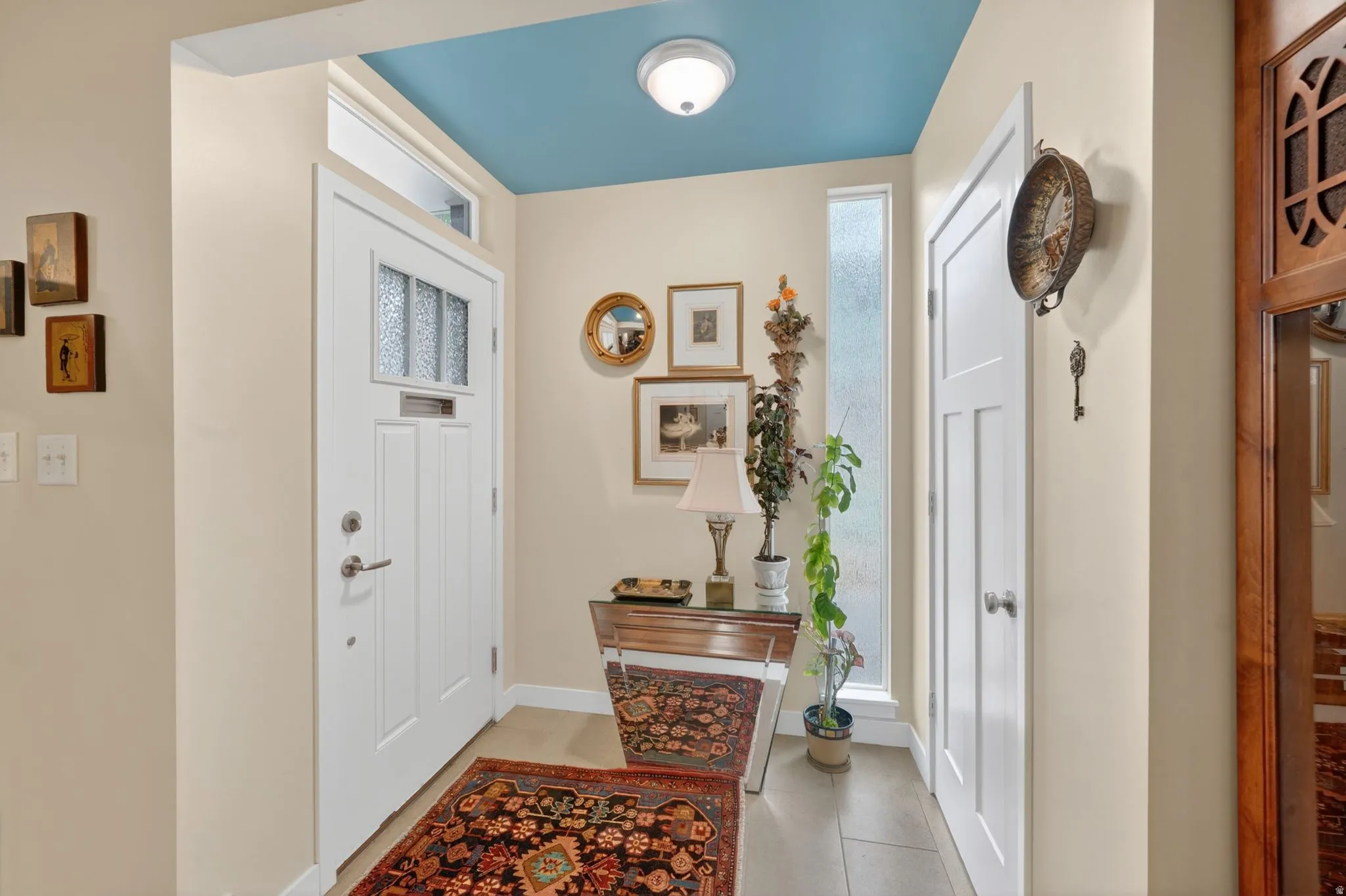 Entryway featuring a decorative front door with frosted glass panels and window