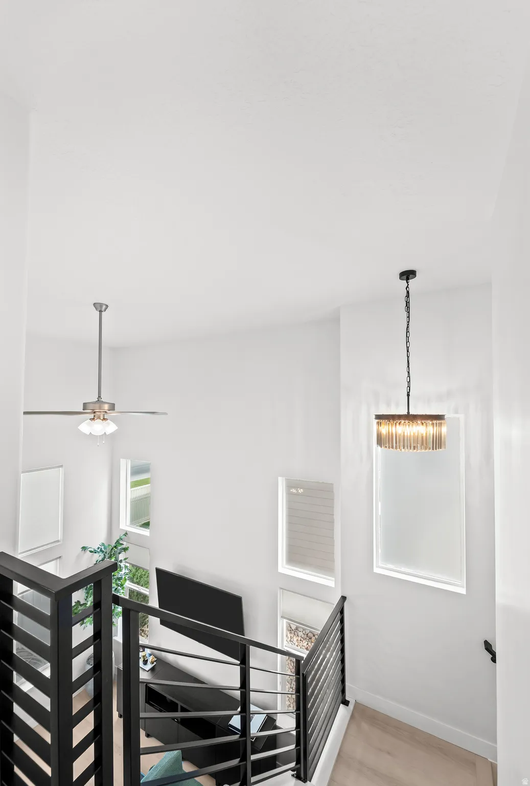 Spacious entry with high ceilings, multiple windows, and light wood-finish flooring